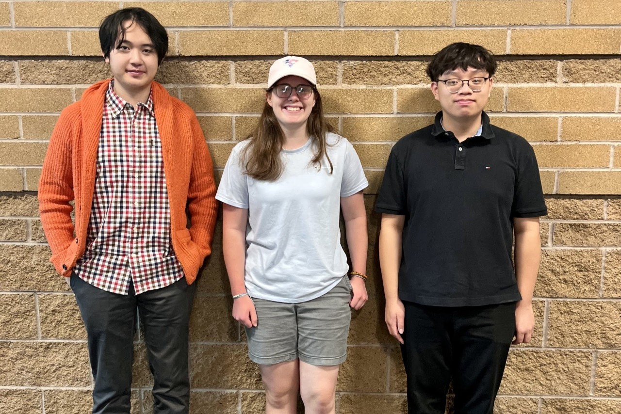 Three students smiling